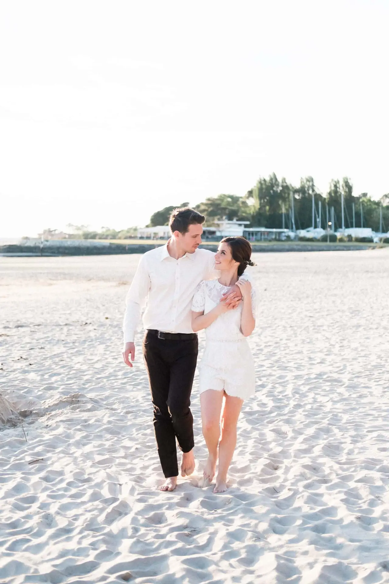 Romantic engagement session on the beach in Provence, barefoot couple walking at sunset