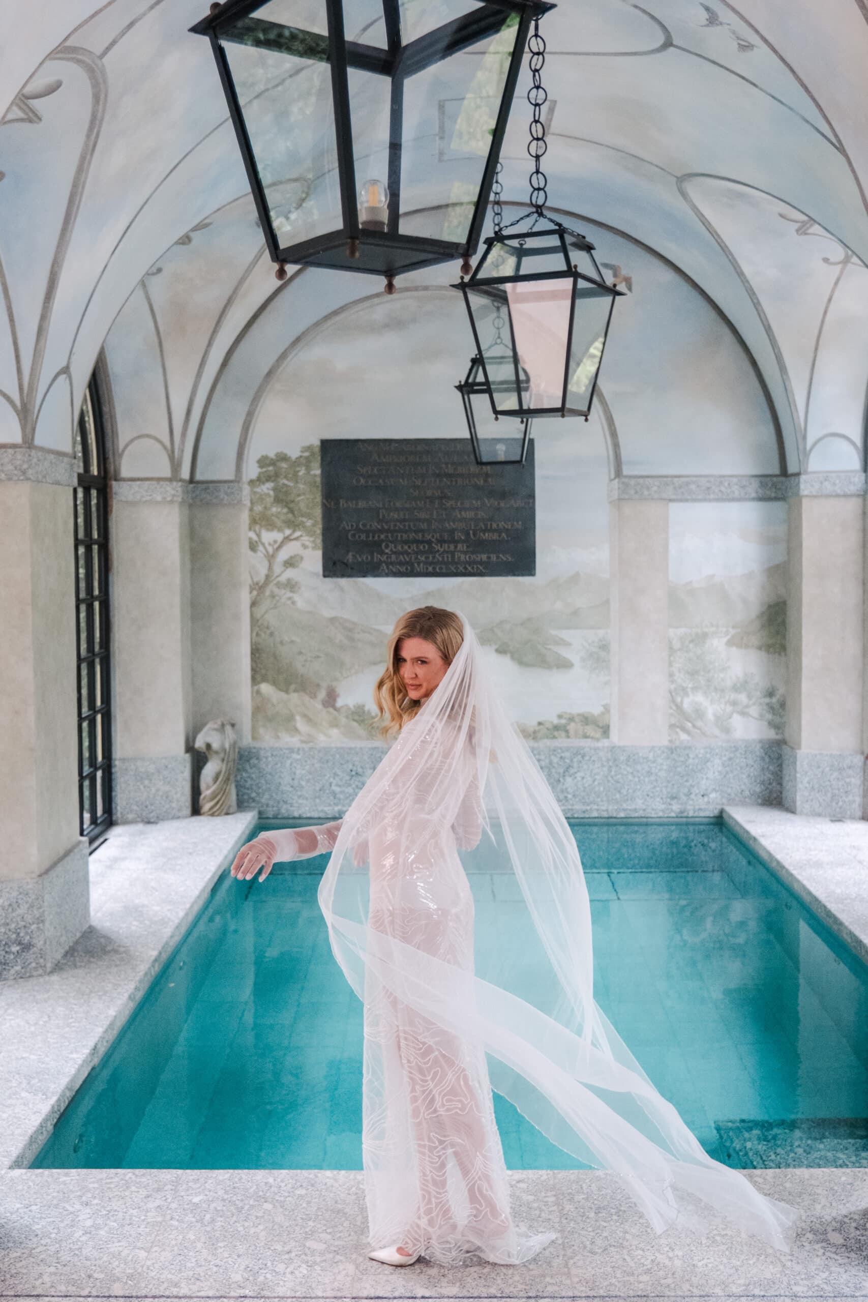 Bride in designer gown by indoor pool, Villa Balbiano wedding, Italy