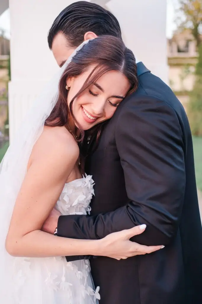 Emotional wedding moment at Château de la Gaude in Provence, bride and groom embrace, beautifully photographed by Julien Boyer