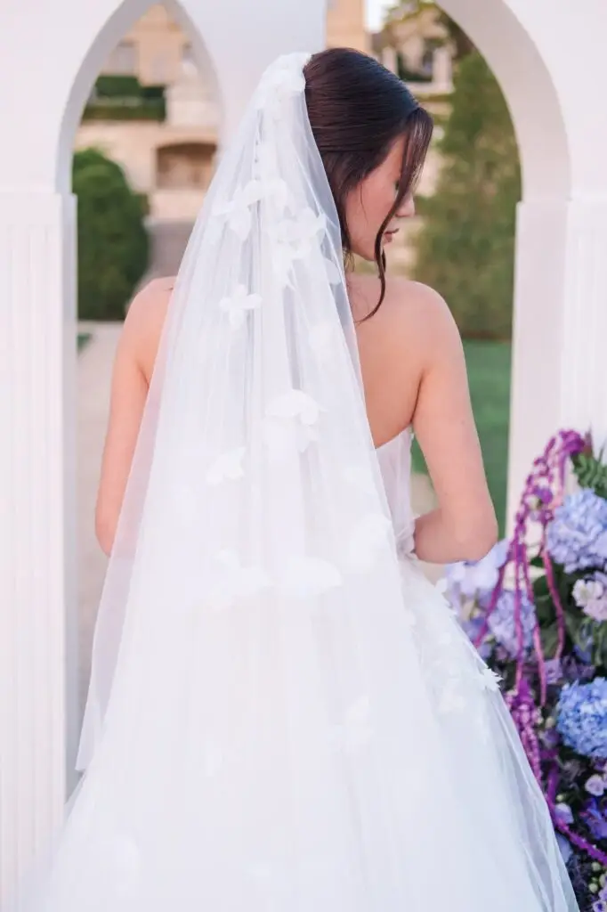 Elegant bridal portrait at Château de la Gaude in Provence, featuring a long floral veil, captured by Julien Boyer, French wedding photographer.