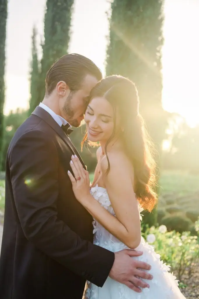 Her smile glows brighter than the Provençal sun as his embrace holds eternity—captured by Julien Boyer