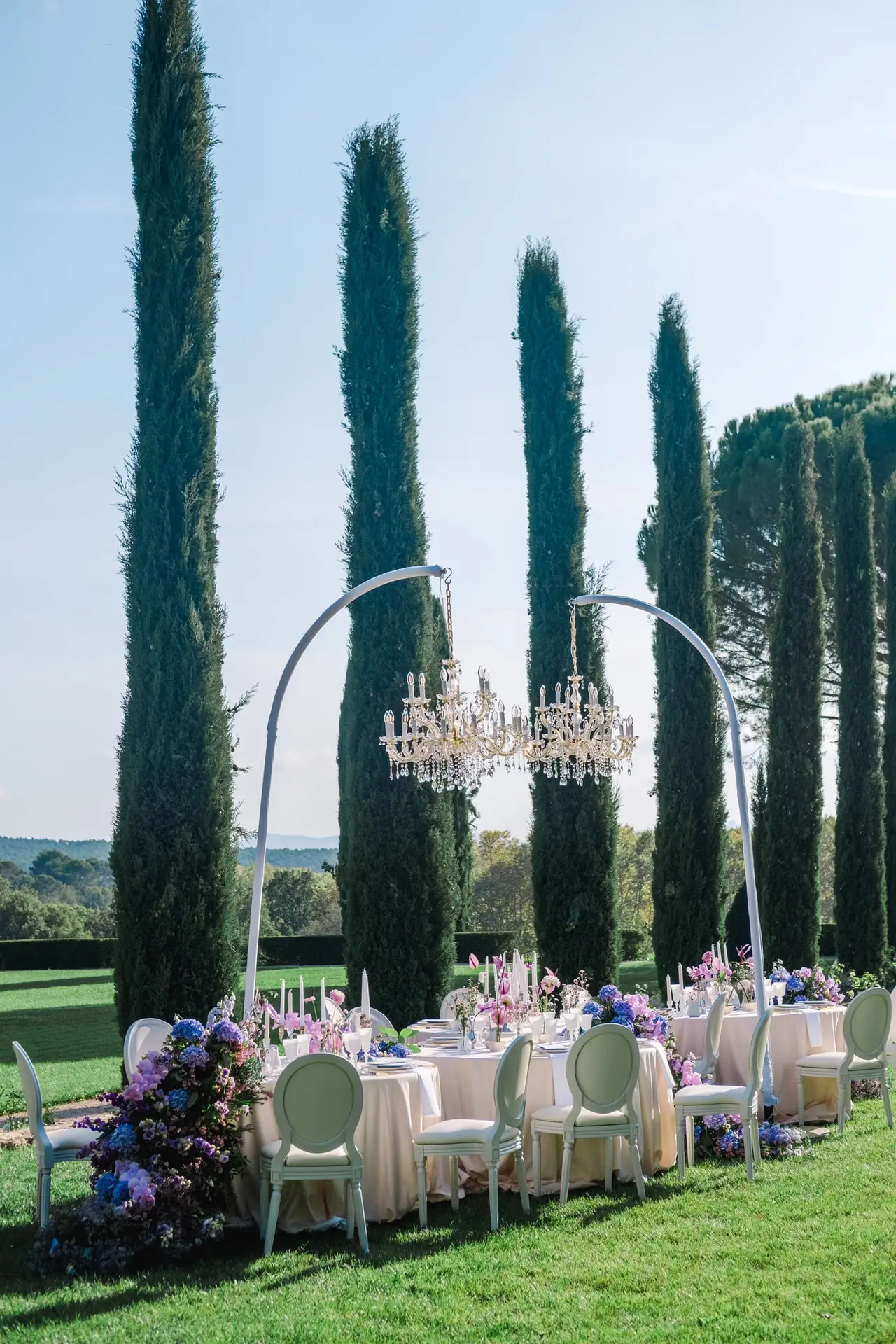 Where Provence skies meet sparkling chandeliers, a feast of love blooms in Julien Boyer’s frame.