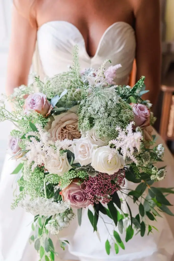 A delicate close-up of the bouquet: soft roses, textured greenery, and pastel blooms. The arrangement mirrors the romance of the Italian lakeside, natural yet refined.