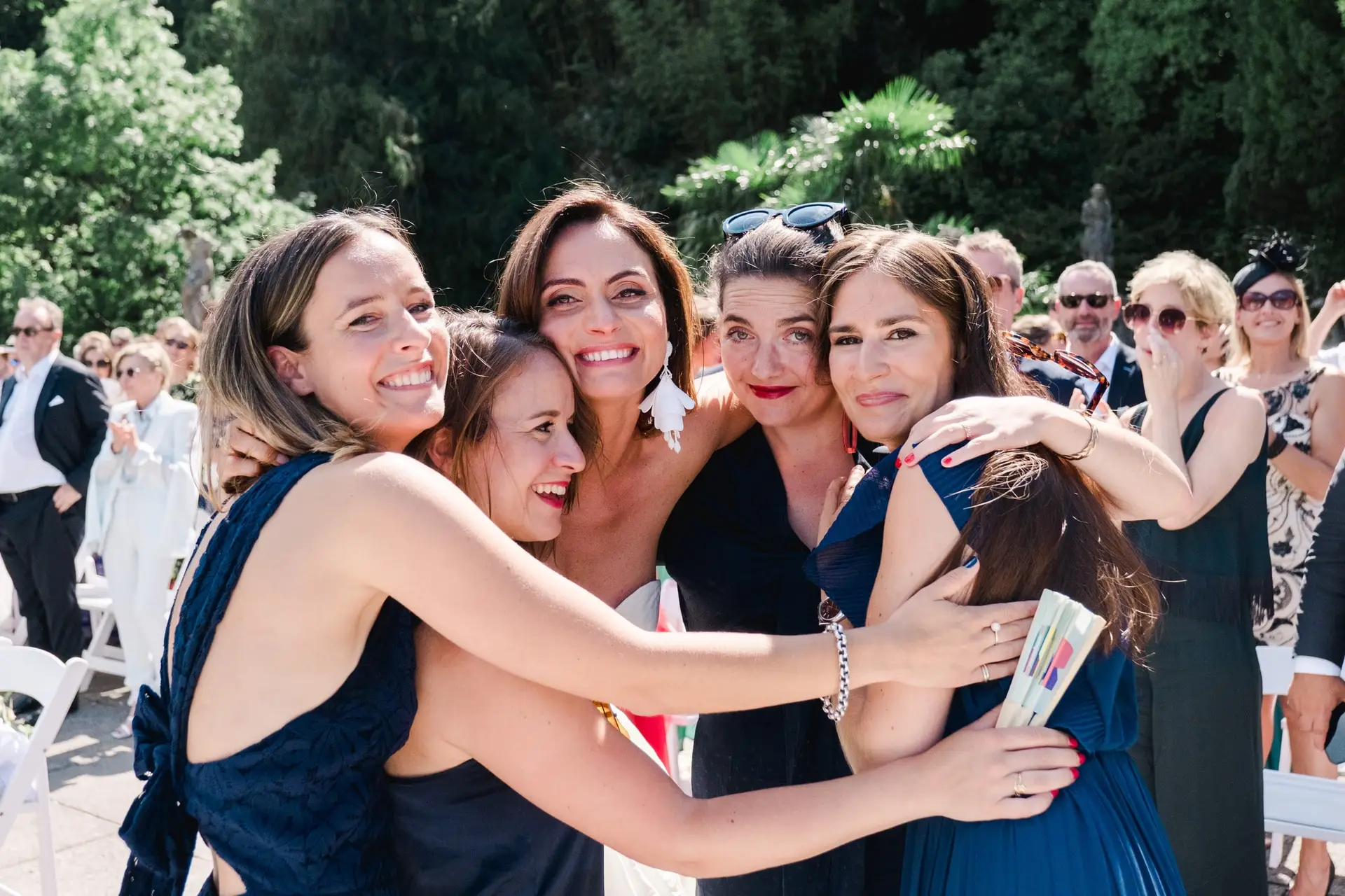 Emotional group hug between the bride and her bridesmaids, celebrating joy and friendship at Villa Pizzo.