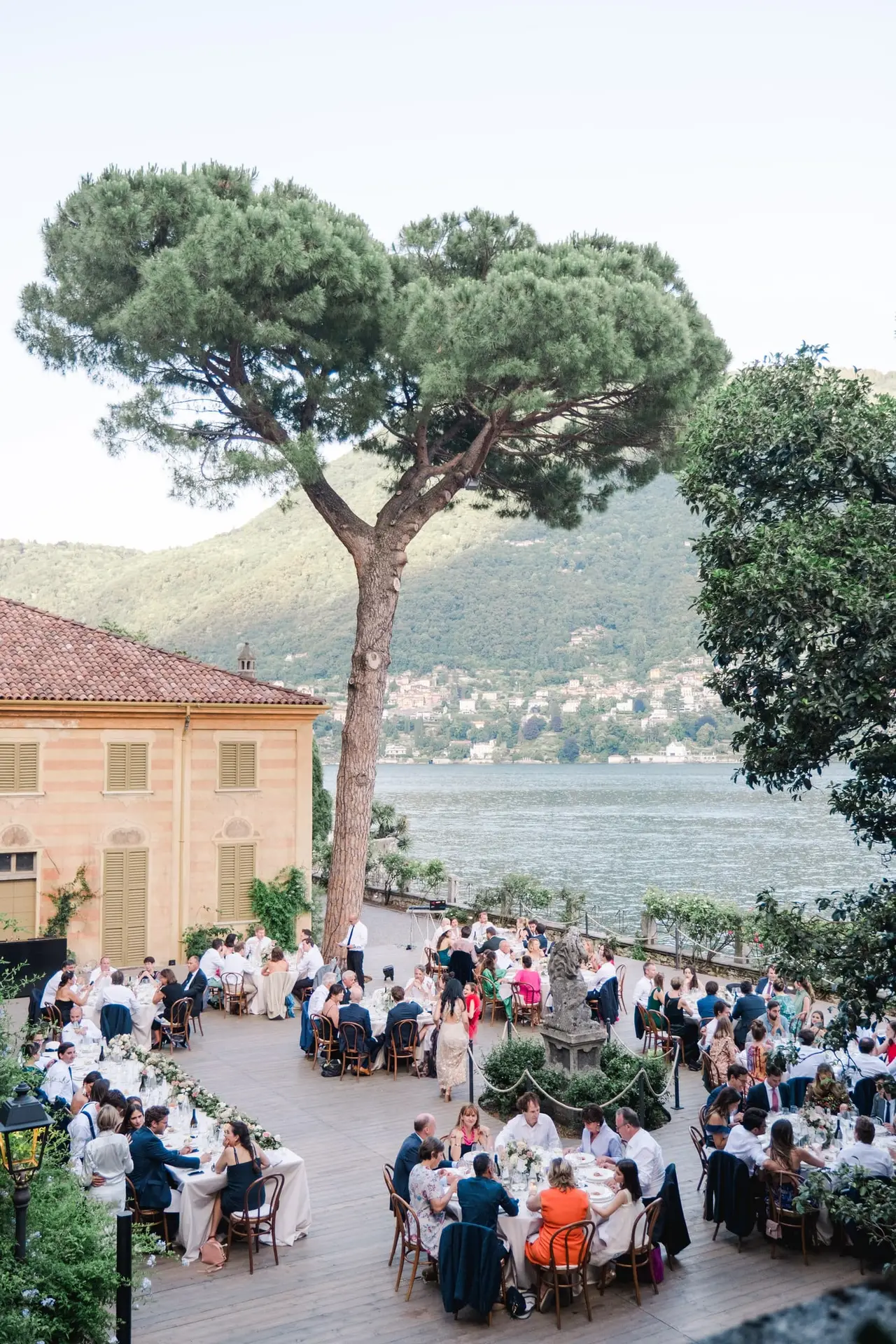 Guests enjoying dinner on the terrace of Villa Pizzo with sweeping views of Lake Como.