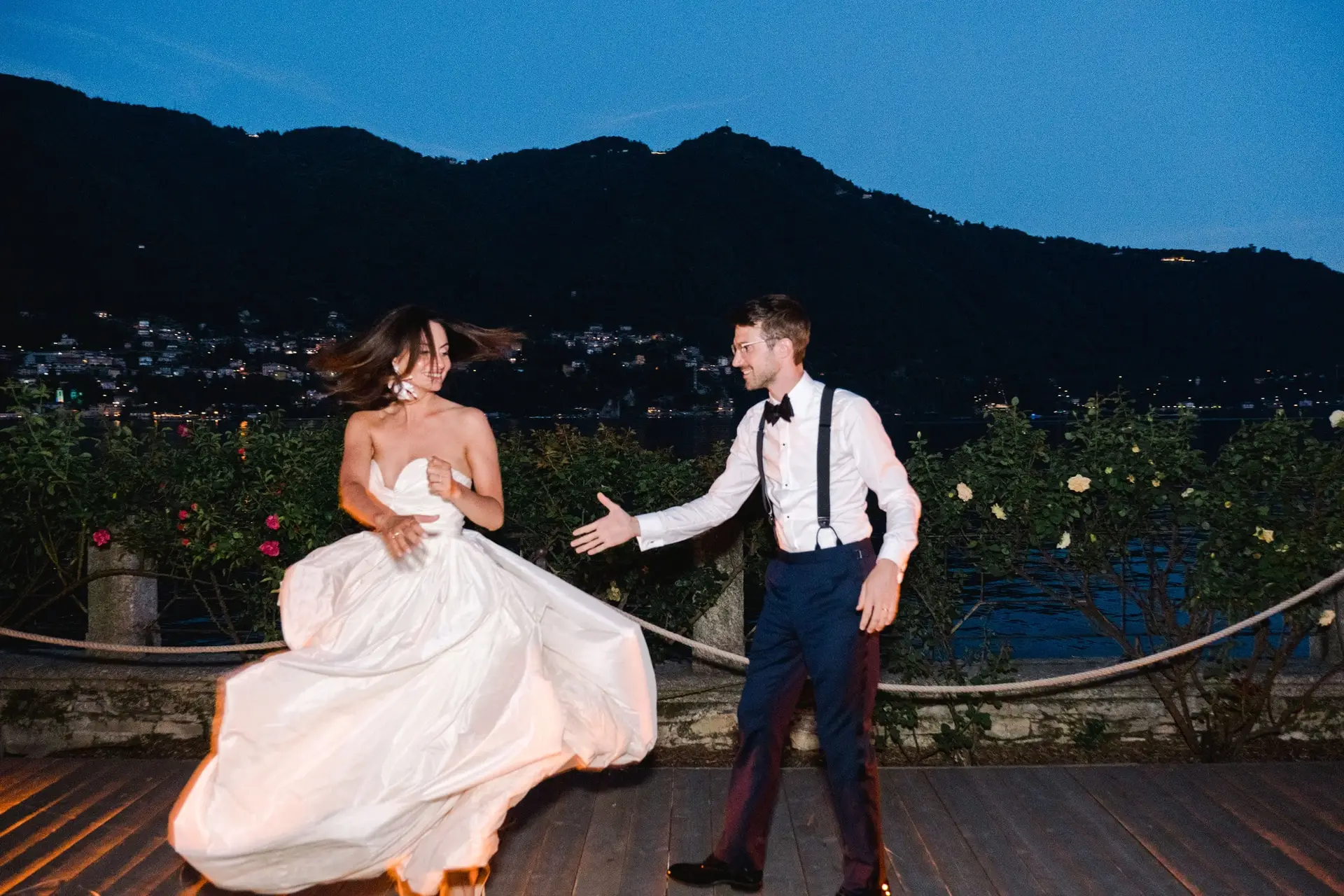 Bride and groom sharing their first dance under the night sky on the terrace of Villa Pizzo.