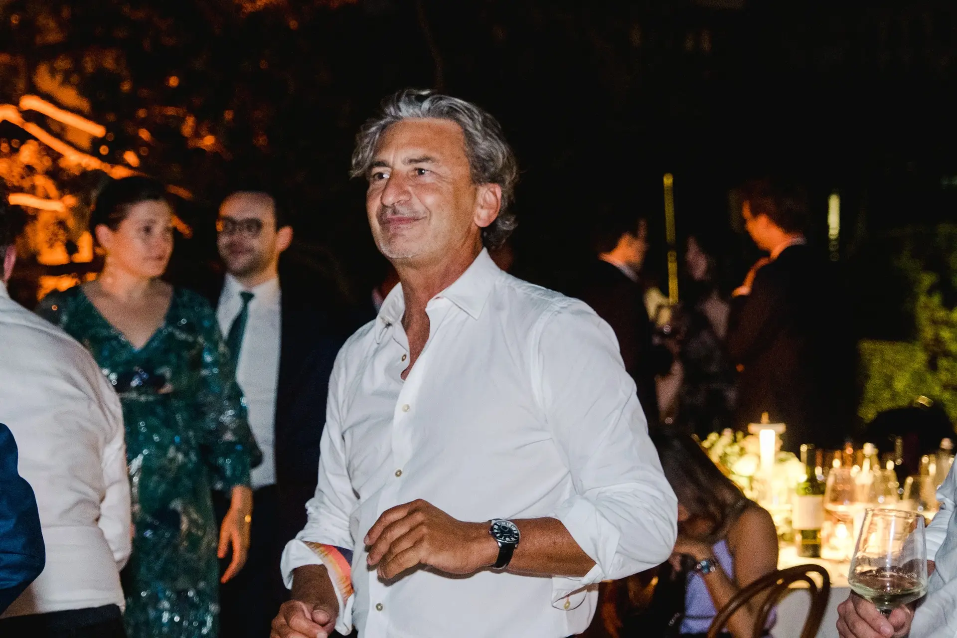 Wedding guest smiling and dancing during the evening reception at Lake Como.