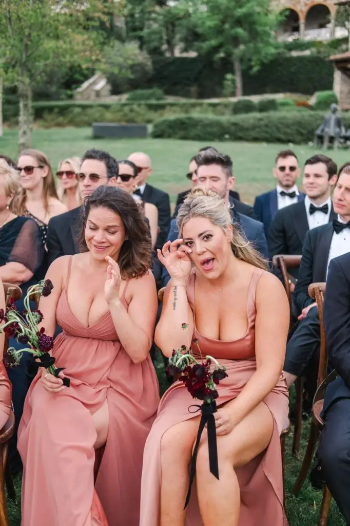 Close-up of bridesmaids wiping tears of joy, touched by the ceremony at Borgo di Corsignano.