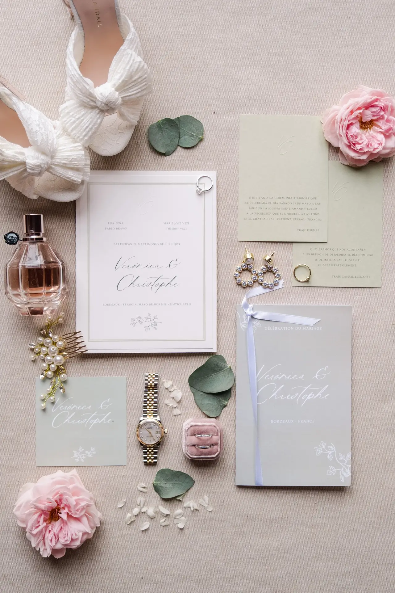 Flat lay de la papeterie de mariage, alliances et accessoires élégants photographiés au Château Pape Clément à Pessac par Julien Boyer
